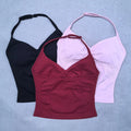 Three tank tops in black, red, and pink on a light blue background