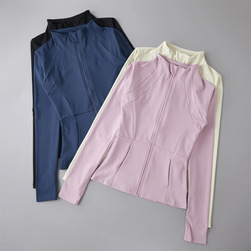 Two jackets, one blue and one pink with white accents, on a gray background.