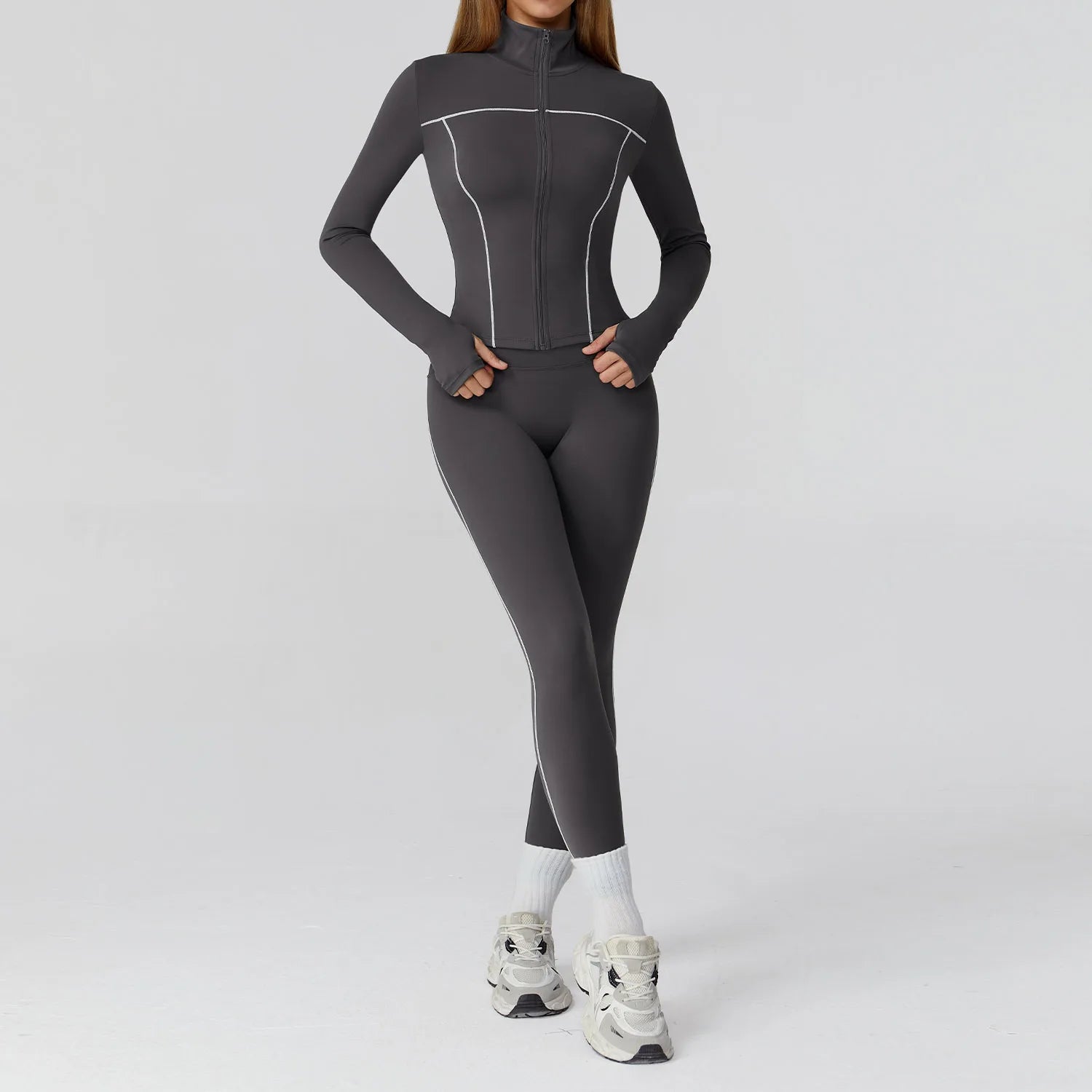 Person wearing a gray full-body suit on a light gray background