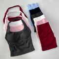 Set of women's tank tops and leggings in various colors on a light gray background
