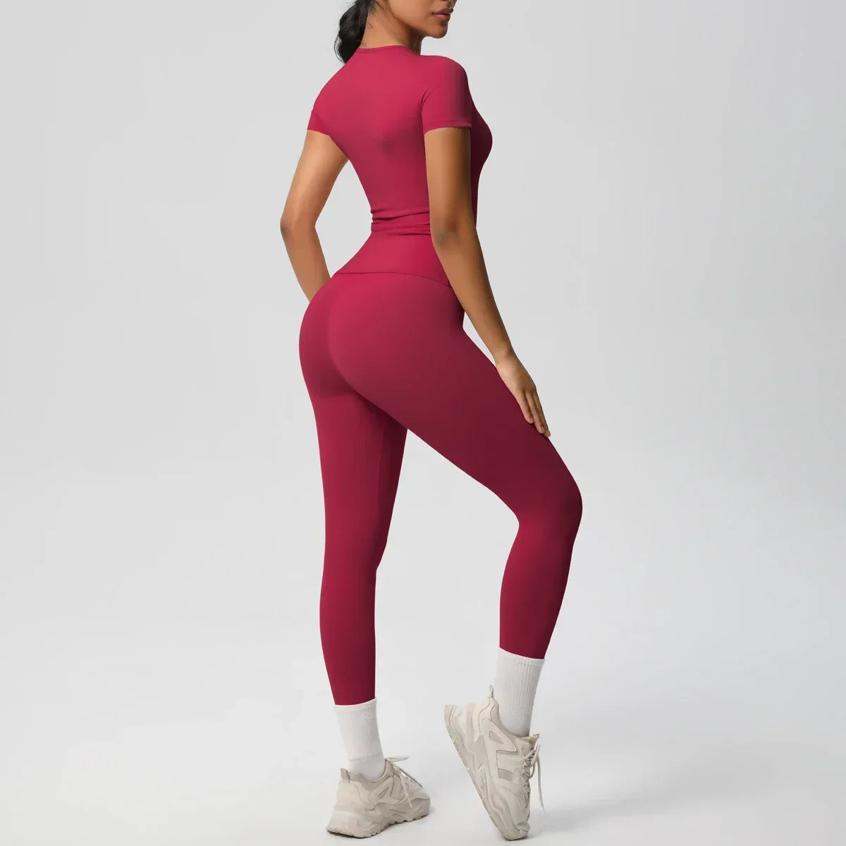 Person wearing a red athletic outfit on a white background