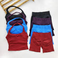 Set of sports bras and shorts in black, blue, and red on a white background
