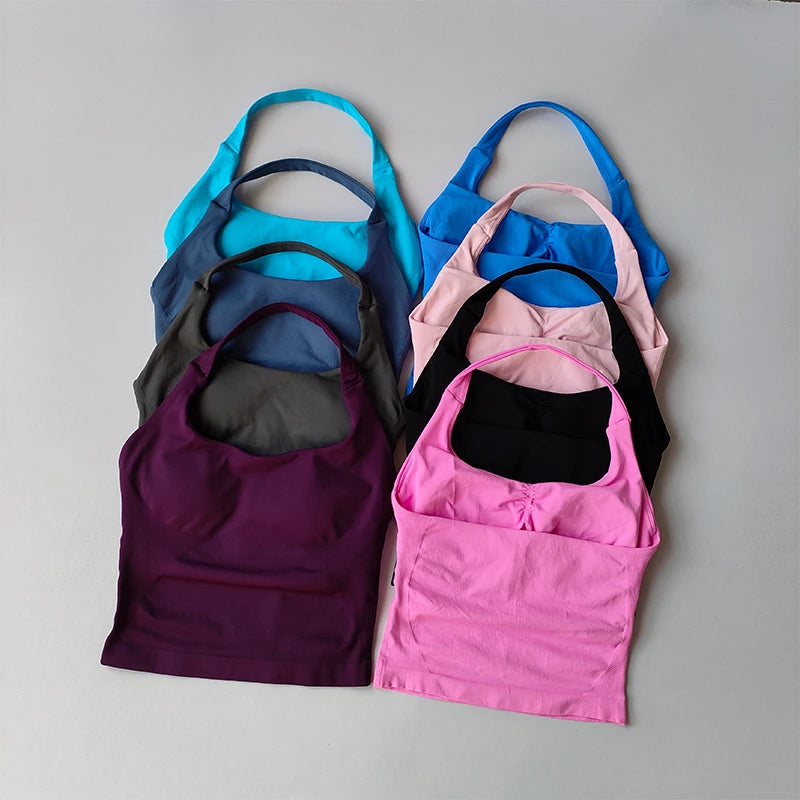 Set of colorful tank tops arranged on a gray background