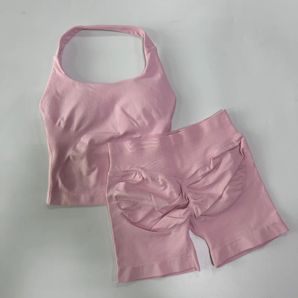 Pink sports bra and shorts set on a light gray background