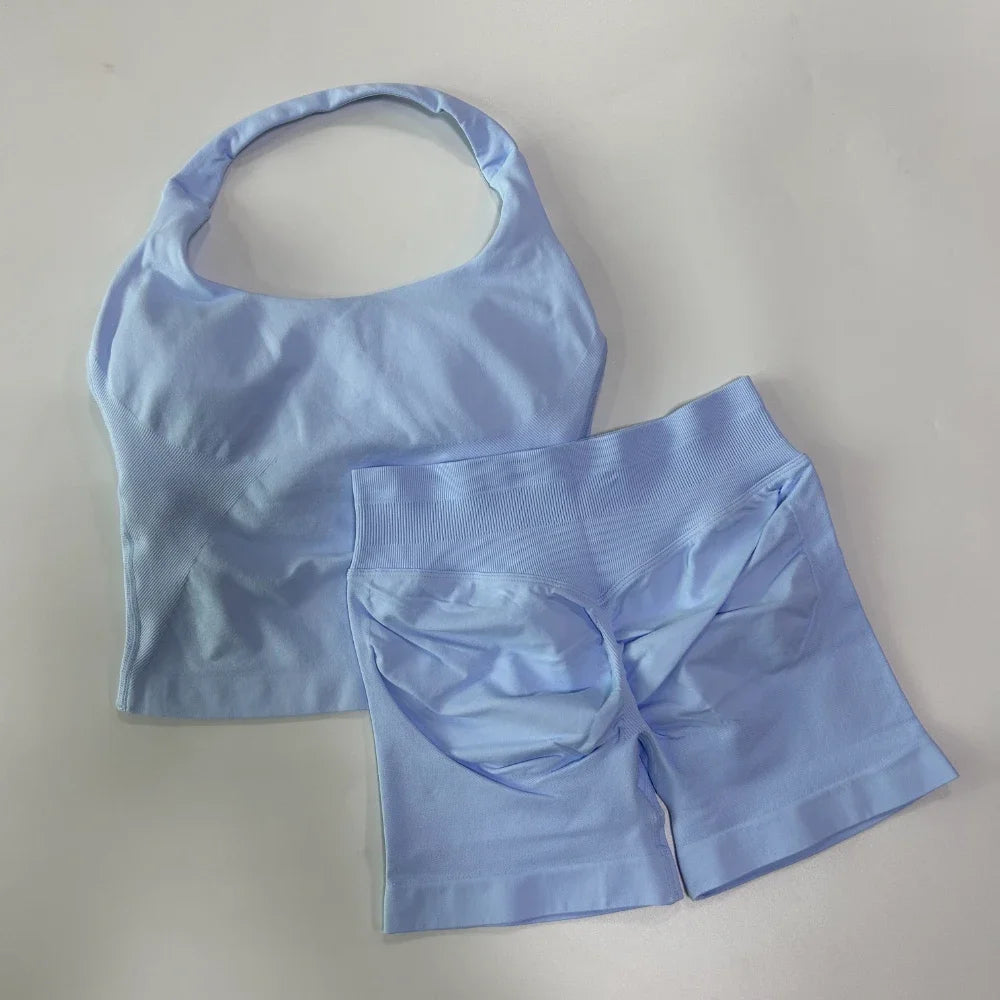 Light blue sports bra and shorts set on a light gray background