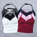 Four tank tops in black, white, pink, and red on a gray background